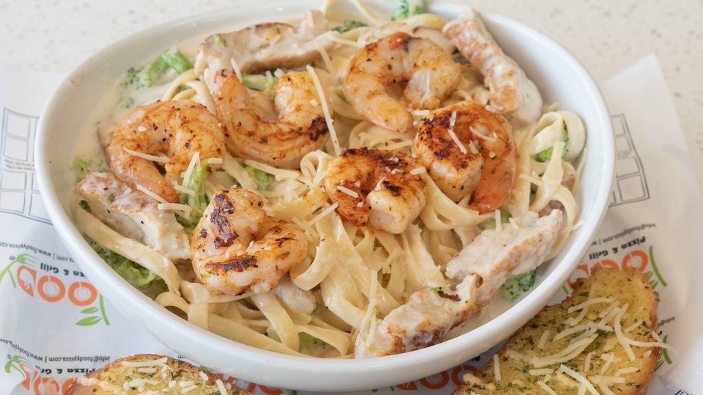 Surf N Turf Alfredo Pasta · Homemade creamy alfredo sauce, fettuccini, marinated jumbo grilled shrimp, marinated grilled chicken, smoked provolone cheese shredded cheese, parsley, and garlic bread.