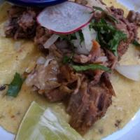 Suadero Taco · Confit beef brisket. Served on a homemade corn tortilla with cilantro and onion. Homemade sa...