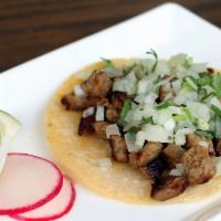 Al Pastor · Marinated pork topped with grilled pineapple, onions, and cilantro.