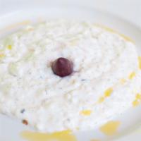 Tzatziki · Greek yogurt dip with pita wedges.