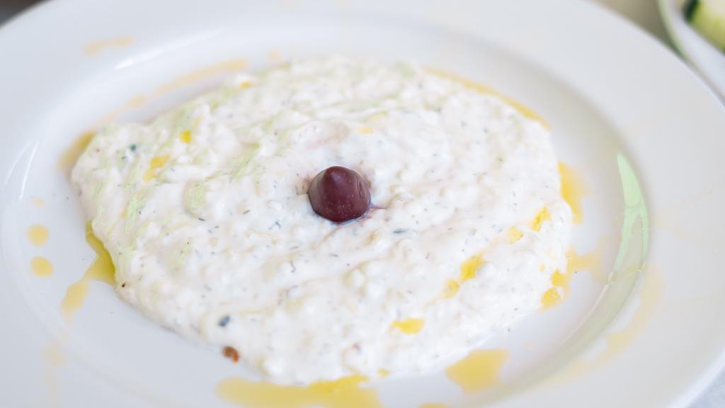 Tzatziki · Greek yogurt dip with pita wedges.