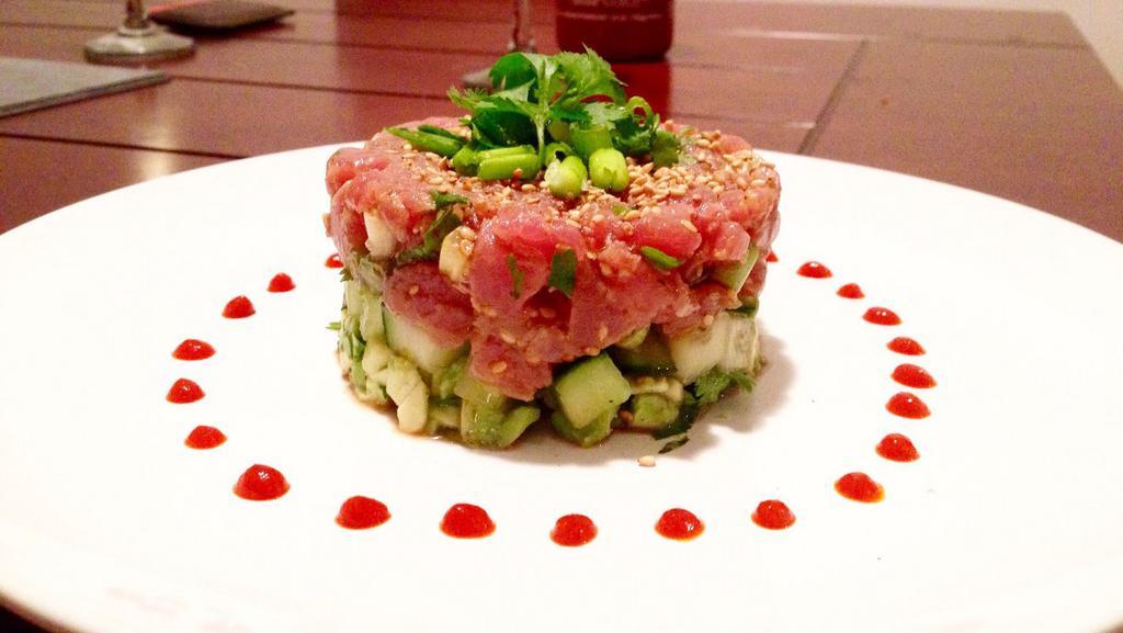 Tuna Tartar S · Raw. Fresh tuna mix with cucumber, mango and avocado tobiko and scallion on top with wasabi yuzu sauce.
