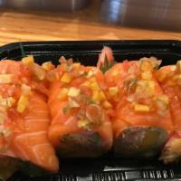 Pink Lady Roll · Spicy crab, mango, avocado, wrapped w. soybean paper, topped w. salmon mango salsa sauce.