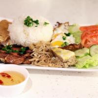 (Cơm Đặc Biệt) · Rice with pork chop, shredded pork skin, pork egg custard, fried egg and bean curd skin.