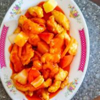 Sweet And Sour Chicken · Topped with onions, carrots, pineapples, and tomato