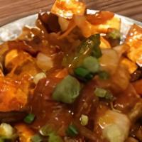 Chili Paneer · Cubed cottage cheese with green pepper, chopped garlic, and herbs. Served with chutneys on t...