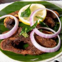 Fish Fry · Flat grilled pomfret fish, marinated with homemade ground spices, herbs, and curry leaves.