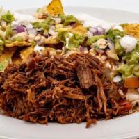 Spicy Beef Nachos · Tortilla chips, choice of Vegan Pinto, Black or refried Bean, Spicy Beef, sour cream, melted...