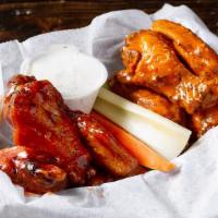 Chicken Wings · Eight large crispy chicken wings tossed in your choice of sauce.