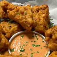 Mac & Cheese Bites · Crispy mac and cheese bites dredged in flour and lightly fried and served with a side of spi...