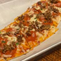Meat Lovers Flatbread · Personal pizza with marinara and melted mozzarella topped with bacon, Italian sausage and pe...