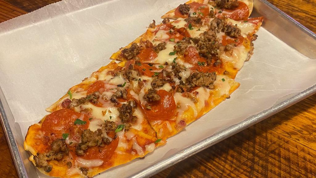 Meat Lovers Flatbread · Personal pizza with marinara and melted mozzarella topped with bacon, Italian sausage and pepperoni