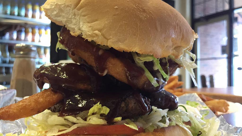 Tex Mex Burger · BBQ sauce, melted mozzarella cheese, onion rings, lettuce, and tomatoes.