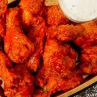 Buffalo Wings · Meaty wings available in mild, hot or BBQ sauce. Served with celery and blue cheese dressing.
