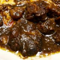 Oxtail · Seasoned marinated oxtail cooked slowly to perfection and served with white rice or rice and...