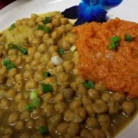 Vegetable Buss-Up-Shot · Fresh chickpeas, potato, and pumpkin cooked and served with roti.