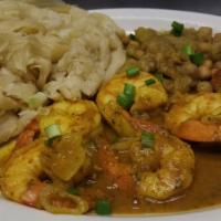 Curry Shrimp Buss-Up-Shot · Jumbo shrimp cooked in a savory curry sauce and served with roti.