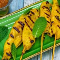 Chicken Satay · Marinated and grilled chicken on skewers, served with cucumber salad and Thai peanut sauce.