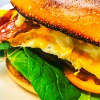 Ranchero · Two fried eggs, bacon, cheddar, fresh red onion, fresh spinach, sliced tomato, chipotle sauc...