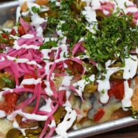 Nachos · Vegetarian, gluten-free. Pickled jalapeño, red onion, sour cream, refried beans, tomato, and...