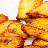 Fried Plantains · Ripe sweet plantains are fried until golden brown with a caramelized texture and sweet flavor.