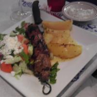 Pork Souvlaki Platter · Tenderloins of pork kebobs served with pita bread and tzatziki sauce.