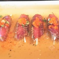 Pepper Tuna Tataki · Sliced pepper tuna seared in special sauce topped with scallions and masago.