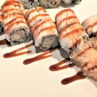 Shrimp Dragon Roll · (In) Shrimp tempura.
(Top) Tiger shrimp & eel sauce.