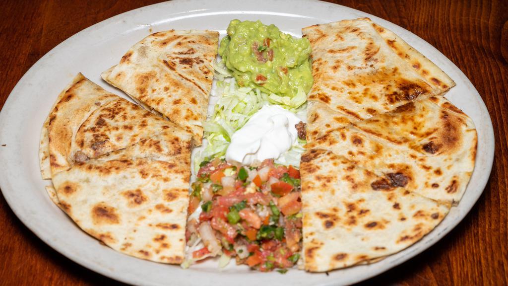 Quesadilla · Choice of filling served with rice, beans, sour cream and guacamole.