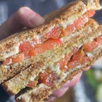 Grilled Cheese With Tomato And Pesto · Grilled cheese with fresh sliced tomatoes and pesto.