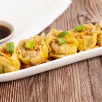 Steamed Dumplings · Steamed dumplings stuffed with shrimp, pork and chicken, served with a special soy sauce.