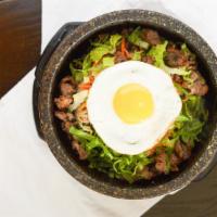 Oishi Gopdol · Hot Stone pot served with marinated vegetables on a bed of rice w/ choice of fried egg accom...