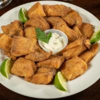 Fried Fish · Traditional fried fish filet, served in cubes with tartar sauce on the side / Peixe frito ac...