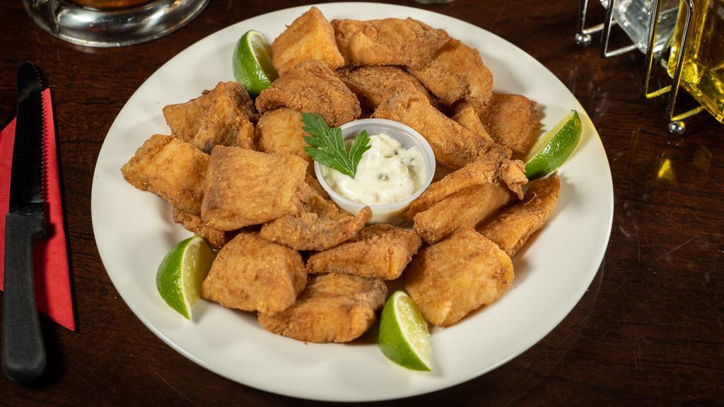Fried Fish · Traditional fried fish filet, served in cubes with tartar sauce on the side / Peixe frito acompanhando molho tartar