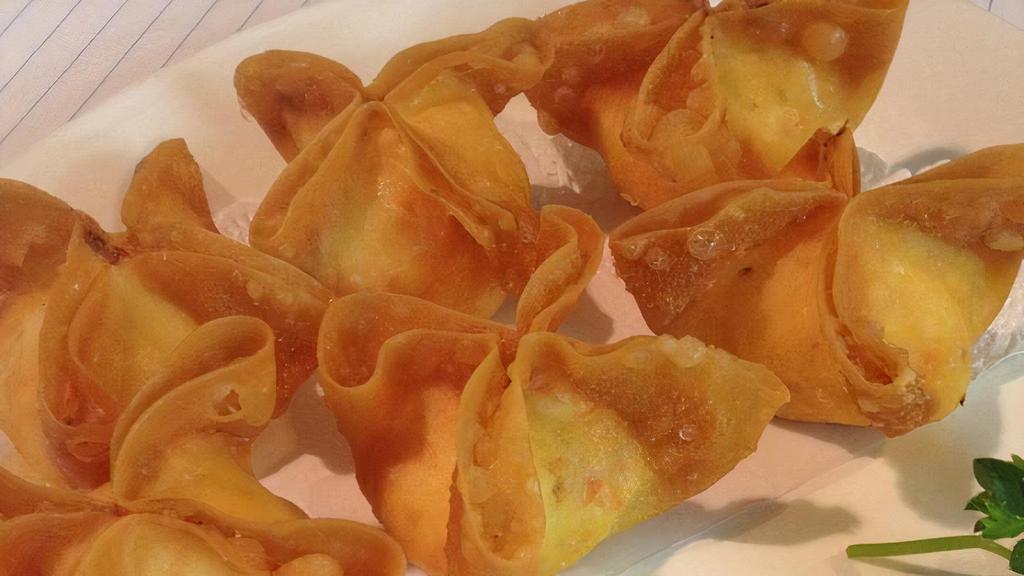 Crispy Crab Wontons (6 Pcs) · Crispy wontons filled with a creamy mix of kanikama, onions, and cream cheese served with a chili plum sauce.