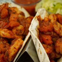 Shrimp Tacos   · chipotle tomato sauce, cabbage lime slaw, cilantro, black beans