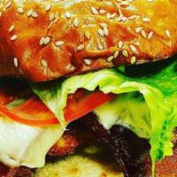 The All American · Fried chicken, American cheese, lettuce, tomato, Kayem bacon and mayo on a grilled buttered ...