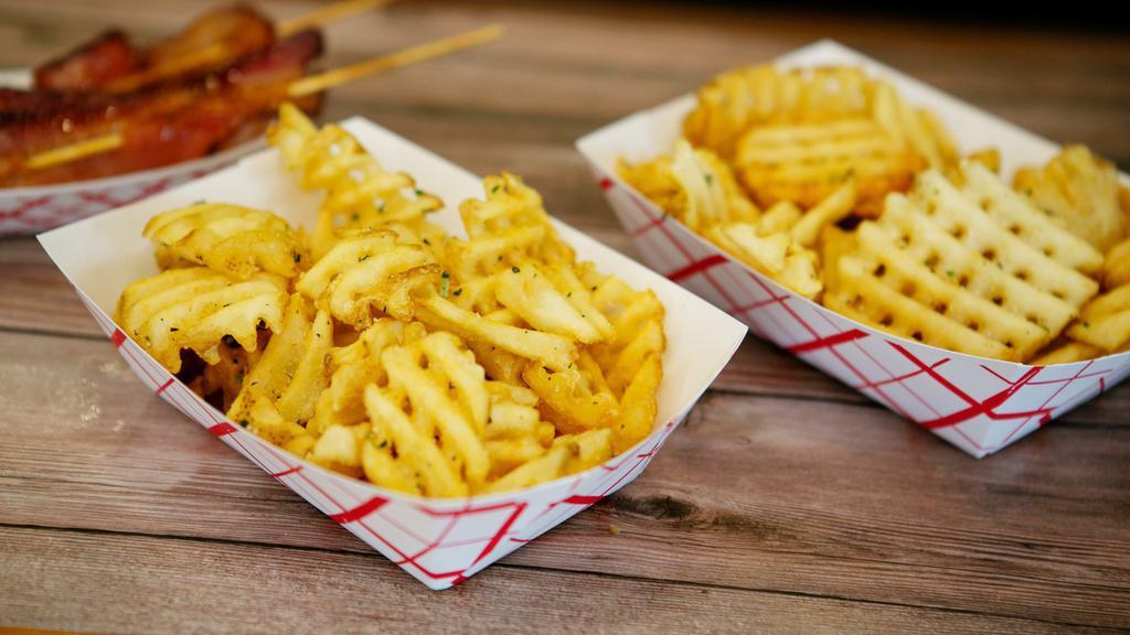 Waffle Fries · Delicious crispy waffle fries served with a choice of specialty ketchups.