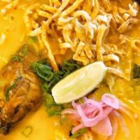 Kao Soi · Spicy. Northern style curry noodle dish with chicken drumsticks, steamed ramen noodle, pickl...