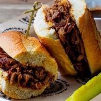 Ancho Beef Dip · Slow-roasted ancho-rubbed tri-tip sliced and stacked to perfection on a baguette. Served wit...