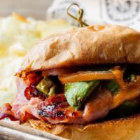 The Mountain · Thinly sliced ham, pecan wood-smoked bacon, tomatoes, avocado, basil mayo, and cheddar chees...