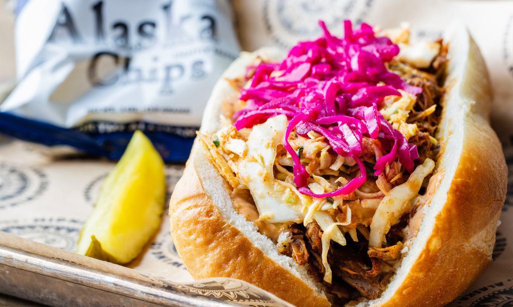 Sweet Cheeks · Brewhouse Fave. Sweet and juicy slow-roasted adobada pulled pork
meets smokin’ chipotle heat on a baguette. Creamy southwest slaw contributes coolness while pickled purple cabbage brings bright colors and bold twang to our most popular sandwich.