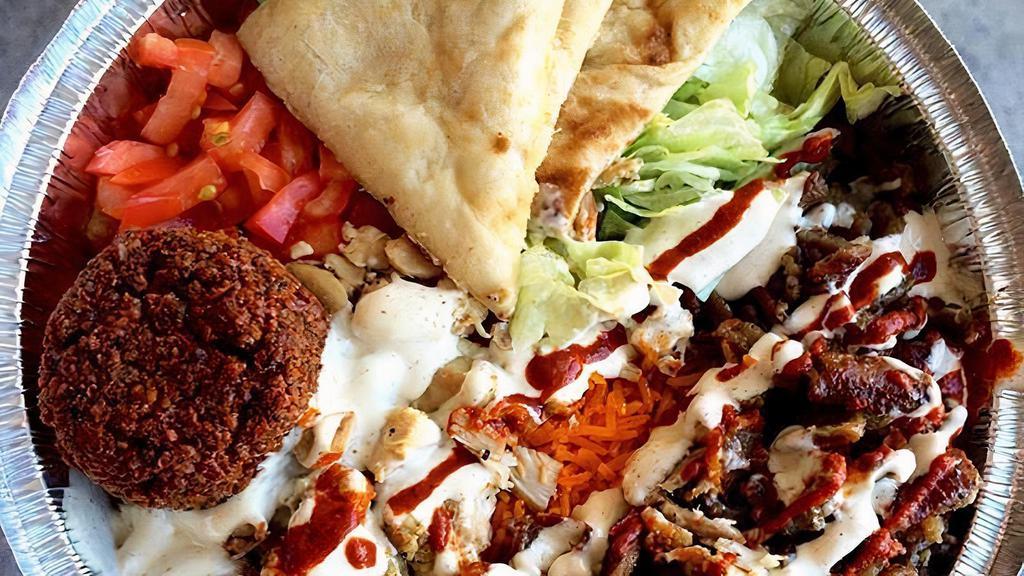 Big Combo Over Rice · Chicken, gyro and falafel combination of the three served with basmati rice and freshly cut salad, a choice of hot or /and white sauce
