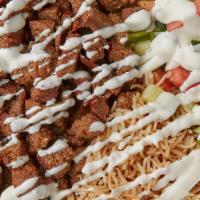 Gyro Over Rice · Lamb gyro over basmati rice served with freshly cut salad, hot sauce and white sauce as you ...