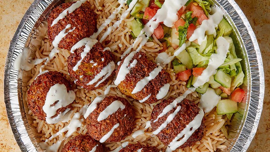 Falafel Over Rice · Veggie falafel ( ground garbanzo chick peas) and other spices, served over rice with freshly cut salad