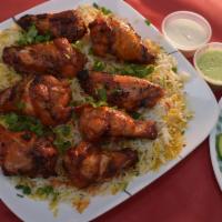 Tandoori Wings Plate · 7 pieces fresh BBQ tandoori wings. Served with spicy or non spicy rice, side of salad and sa...