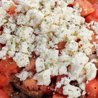 Cretan Salad · Crispy dako bread topped with chopped tomatoes,feta cheese,and kalamata olives. Drizzled wit...