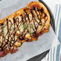 Prosciutto & Fig  Flatbread · With Gorgonzola cheese and balsamic glaze. Served on a wooden pizza board with a handle.