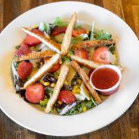 Strawberry Chicken Salad · Spring mix, crispy chicken, walnuts, corn, Parmigiano-Reggiano, and strawberries in a raspbe...
