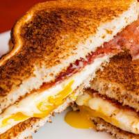 Egg, And Cheese With Meat Sandwich · Fried egg, american cheese, choice of breakfast meat, and choice of sliced bread.